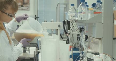 Scientist working in a pharmaceutical laboratory conducting experiments, Stock Footage