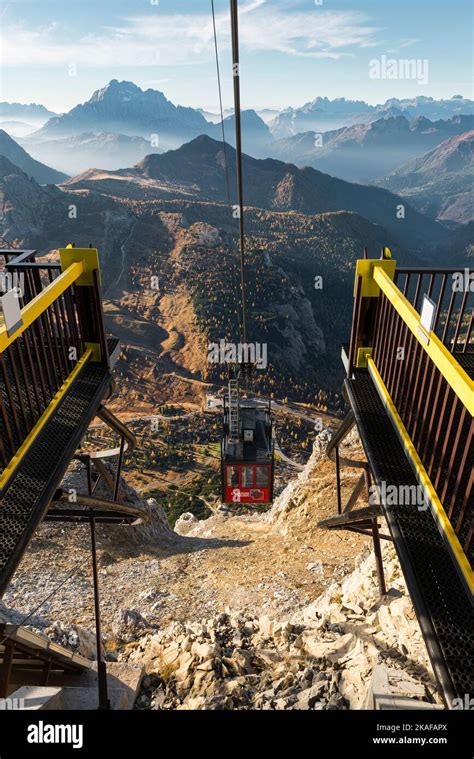 A gondola of the Lagazuoi cable car approaches the top station in front ...