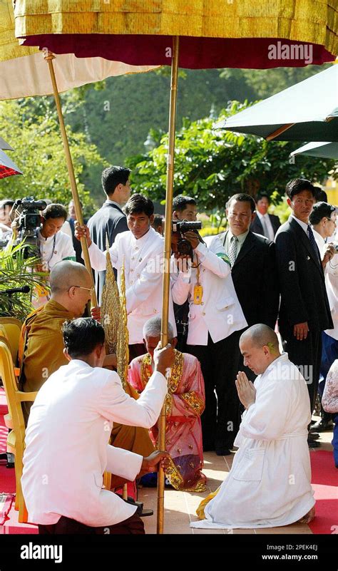 King Norodom Sihamoni prays to Buddhist monks after the bathing ceremony at the Royal Palace in ...