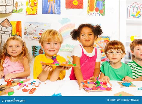 Happy Kids With Modeling Clay In Classroom Stock Photo - Image: 48811589