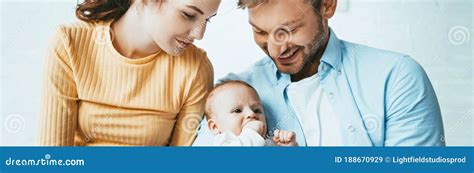 Shot of Happy Parents Smiling while Looking at Cute Infant Stock Image - Image of together ...