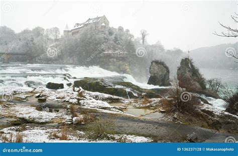 Rhine Falls in Switzerland on a Winter Day with Snow Falling Stock ...