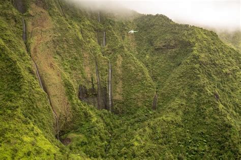 Premium Photo | Aerial view of waterfalls in crater of mount waialeale ...