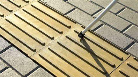 Blind Person Using White Cane on Straight Tactile Tiles To Navigate ...