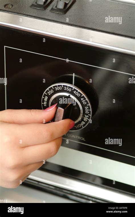 A female hand adjusts the dial on an oven for 350 degrees Fahrenheit Stock Photo - Alamy