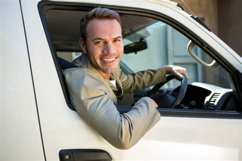 Premium Photo | Delivery man driving in his van