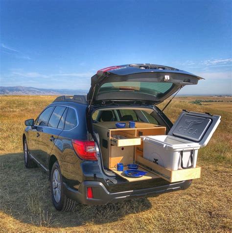 the back end of a car with its trunk open and two coolers in it