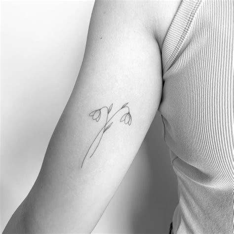 Fine line style snowdrop flower tattoo placed on the | Flower tattoo ...