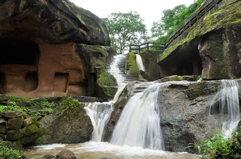 the waterfall is running down to the caves in the rock formations that look like they have been ...