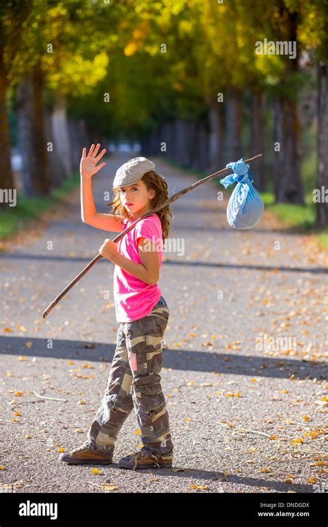 little kid with hobo stick bag and bundle girl saying goodbye with hand Stock Photo - Alamy