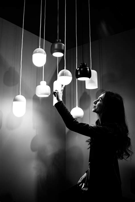 Grayscale Photo of Woman Touching Pendant Lights · Free Stock Photo