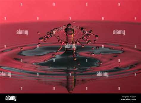 Water drop on the red background Stock Photo - Alamy