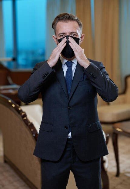 Premium Photo | Corporate business man wearing protective medical face mask at luxury office