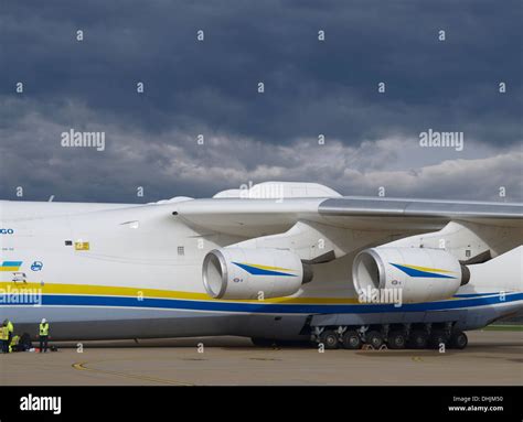 Antonov An-225 Mriya airplane during loading. Four loading workers can ...