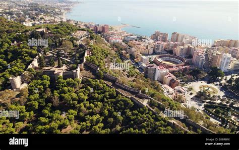 A beautiful aerial view of the fortress of Alcazaba in Malaga, Spain surrounded by lush trees ...