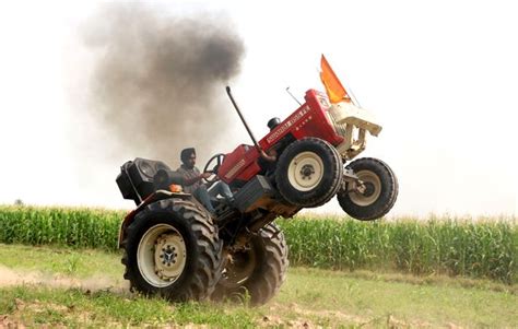 Daredevil farmer performs unbelievable tricks on his tractor including ...