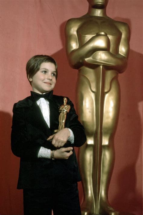 Ten-year-old Tatum O'Neal holding her Oscar after winning the Best ...