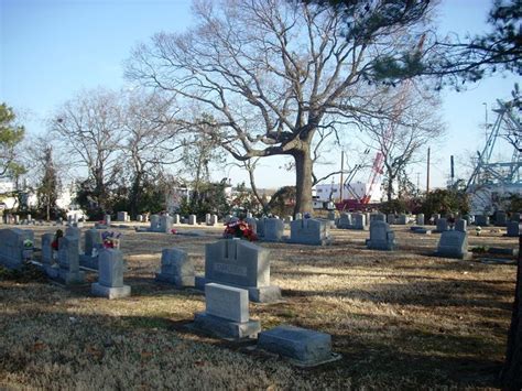 a cemetery with headstones and trees in the background