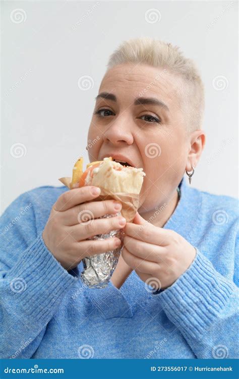 White Woman with Short Hair Enjoying Greek Gyro Sandwich. Portrait of a Hungry Female Person ...