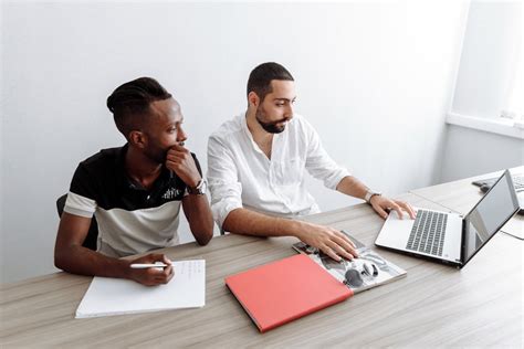 Men using Laptop while Working Together · Free Stock Photo