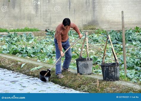 Pengzhou, China: Farmer Watering Seedlings Editorial Photo - Image: 22192221