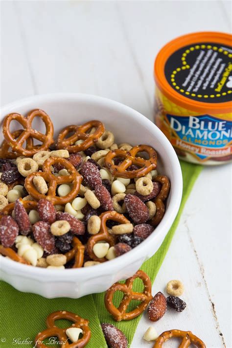 a bowl filled with cereal and pretzels next to a can of blue diamond