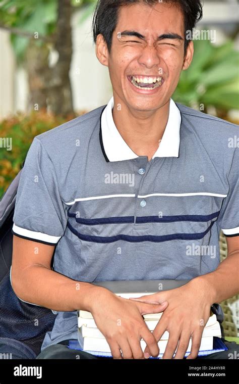 Boy Student Laughing With Books Stock Photo - Alamy