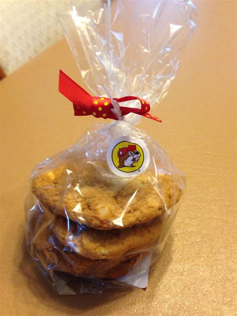 three cookies wrapped in plastic sitting on top of a table