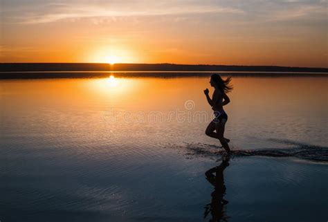 Woman Running on the Beach at Sunset Stock Photo - Image of action, lake: 118910192