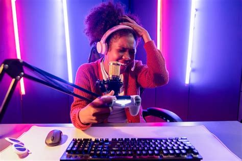 Premium Photo | Host channel of gaming streamer African girl playing online game with joystick ...
