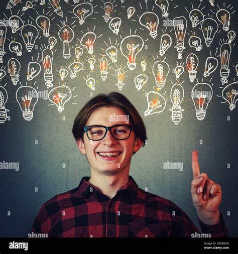 Joyful guy pointing index finger up, showing multiple light bulbs as creative ideas isolated on ...