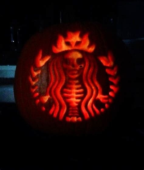 a starbucks pumpkin carved to look like a skeleton