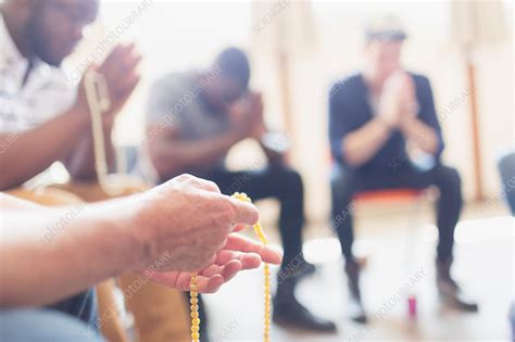 Men praying with rosaries in prayer group - Stock Image - F023/9249 ...