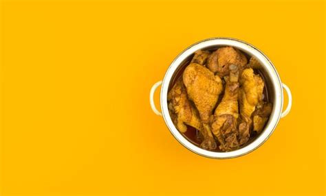 Premium Photo | Roasted chicken in a saucepan, yellow and orange ...
