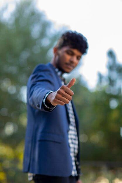 Premium Photo | A young businessman thumbs up with a blue suit