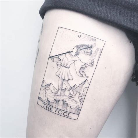 Fine line 'The Fool' Tarot Card tattoo on the thigh.