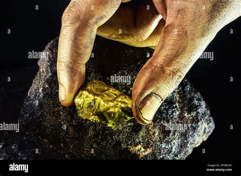 large gold stone being removed from mine, concept of mineral extraction ...