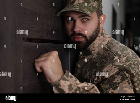 Military commissariat representative knocking on wooden door Stock Photo - Alamy