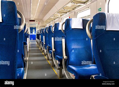 Interior of a modern intercity express train. Back view of wide ...