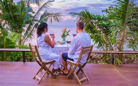 Premium Photo | Rear view of woman sitting on lounge chair at outdoor cafe