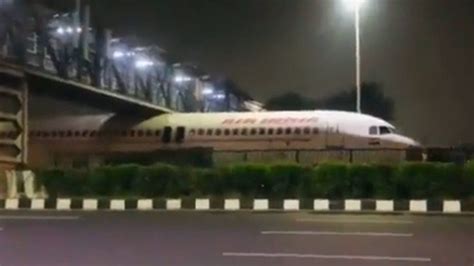 Air India: Plane stuck under bridge in viral video - BBC News