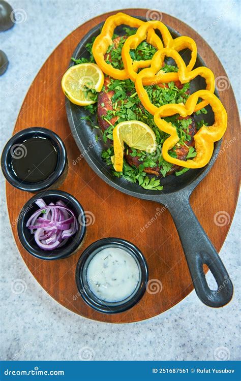 Deep Fried Whole Brisket in a Cast-iron Skillet with Sauces and Garnish Stock Image - Image of ...