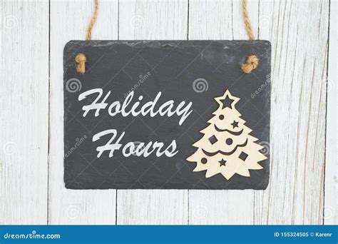 Holiday Hours Sign on Chalkboard with Christmas Tree Stock Image ...