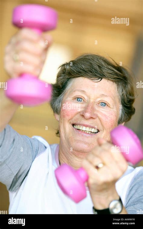 Older woman trains with dumbbells Stock Photo - Alamy