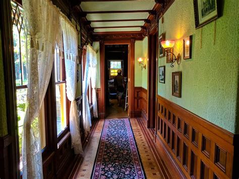 Winchester House Corridor with Wooden Paneled Walls and Windows