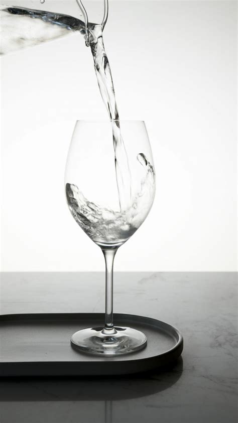 Water Being Poured into a Clear Wine Glass · Free Stock Photo