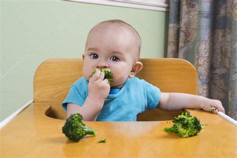 Cute baby eating broccoli — Stock Photo © red_pepper82 #69268301