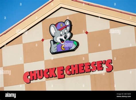 A logo sign outside of a Chuck E. Cheese restaurant location in Waldorf ...