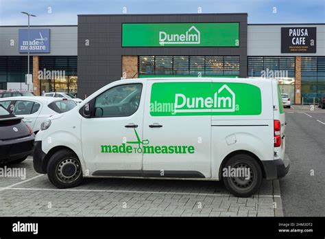 Dunelm logo brand for a made to measure curtain service via Peugeot Expert white van in retail ...