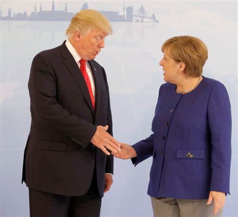 Trump shakes hands with Merkel - Rediff.com India News